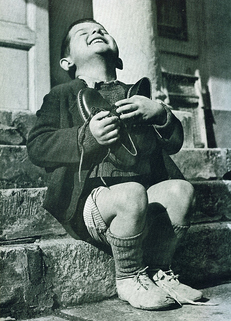 Austrian boy receives new shoes during WWII.