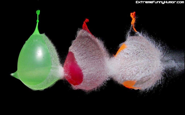 Neat picture of a bullet going through 3 waterballoons.