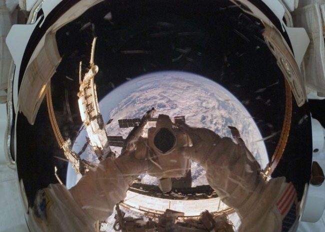 Astronaut doing a myspace angle in space.