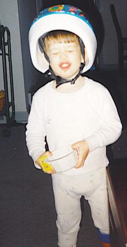 A little boy gets his new helmet on christmas morning.