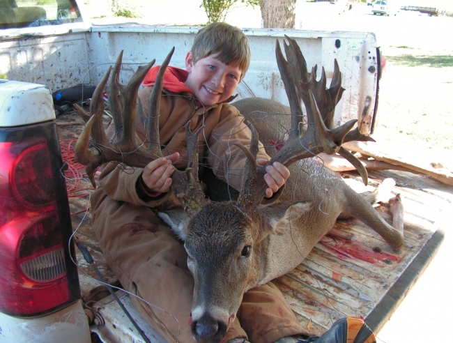 this buck was taken by the nine year old in the picture, the boy shot the deer in they're family garden.