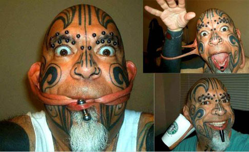 A man with tattoos who does strange things with his ears. From funnycage.blogspot.com, not from me