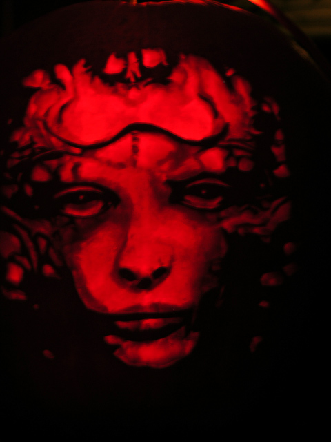 Girl's face, carved into a Halloween pumpkin - from H.R. Geiger's collection of designs for the Alien movie series . Carved by T. Bonkowski