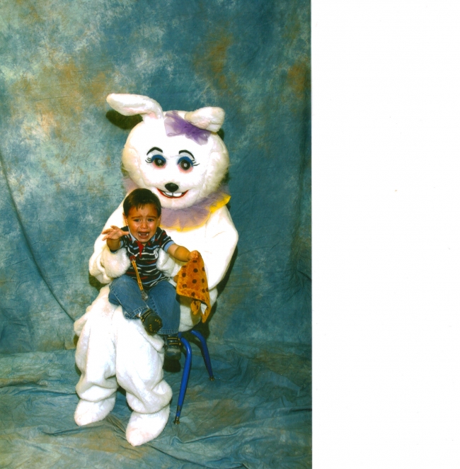 Little boy meeting Easter bunny for the first time.