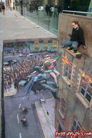 Funny picture of sidewalk art that looks like a man is stranded and batman and robin are coming to rescue him