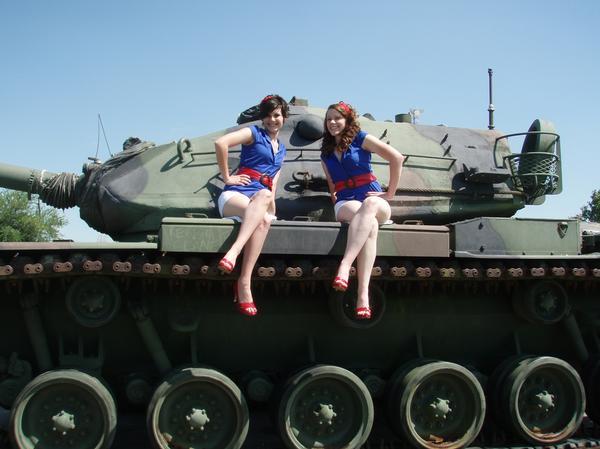 two cuties on a tank posing like pin-ups