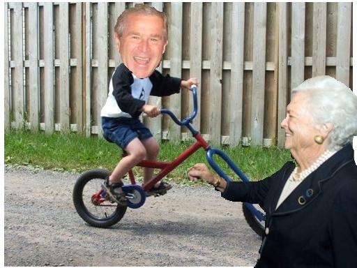 Little George Bush riding his bike. Momma Barb looks so proud!!