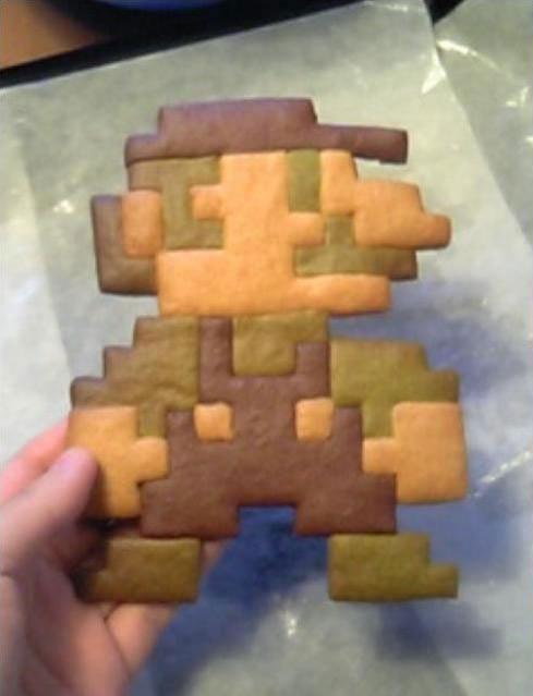Someone made a cookie in the shape of the original pixel Mario.