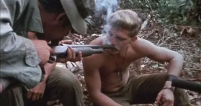 Shotgunning is when one person blows into one end of a smoke filled pipe, forcing it into the other person's lungs.  This originated from U.S. Soldiers in Vietnam who developed a system to smoke out of shotguns, as pipes were not readily available.  Ingenious!