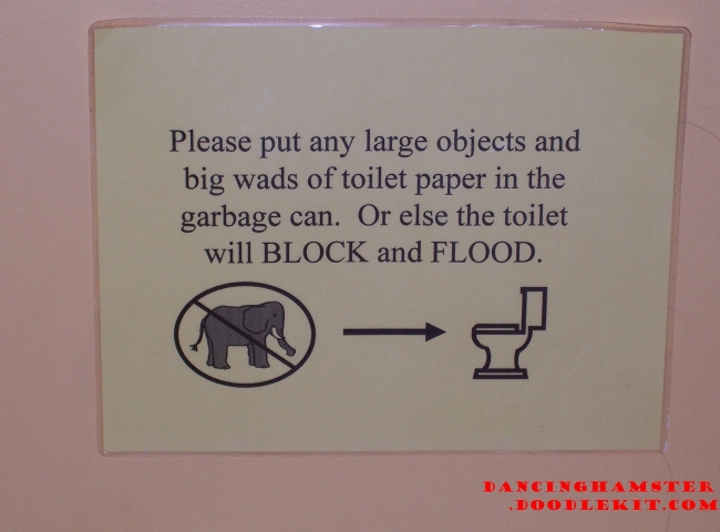 A sign above a toilet telling you not to put elephants in the toilet.