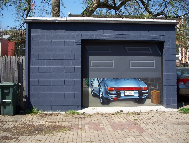 Local Washington, DC, artist Mark Walker painted this trompe l'oeil rendering on the garage door of a retired government worker.  The owner and his wife had given up their very favorite 1985 Porsche Carrera five years ago and needed something to remember it by.  That memory is now this painting on their garage door.