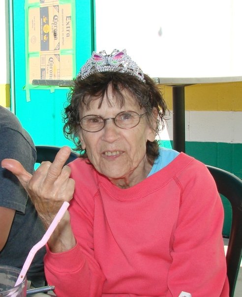 Sweet old lady flipping the bird while wearing a tee-era.