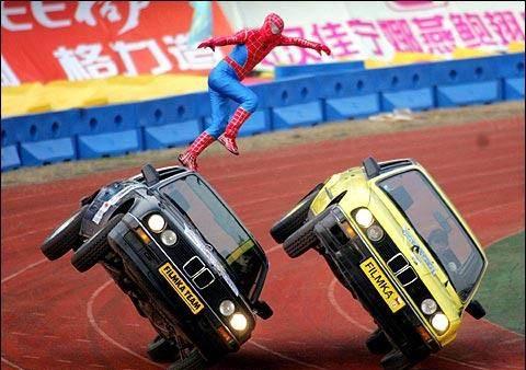 Spider Man Jumping From Car To Car While There On 2 Wheels
