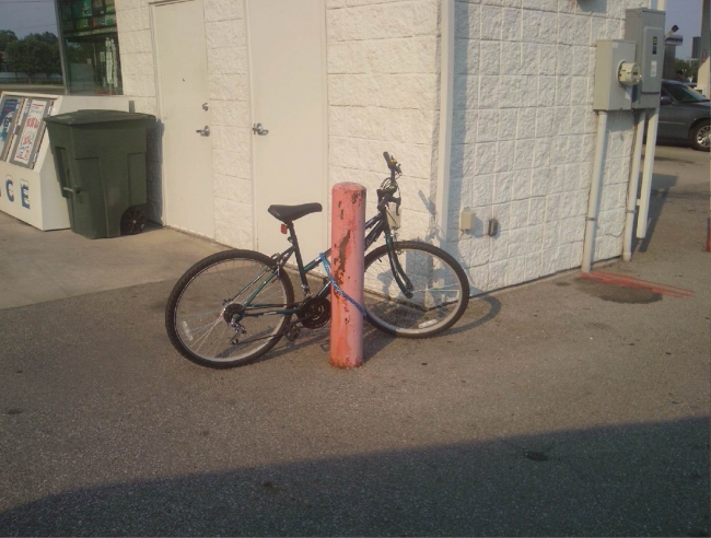 the owner of this bike works at kroger, a local supermarket. i was at the gas station when she rode up and chained it to this concrete post. i should have stolen it. out of principle. to teach her a lesson. although, i dont think she would get the point based on her actions