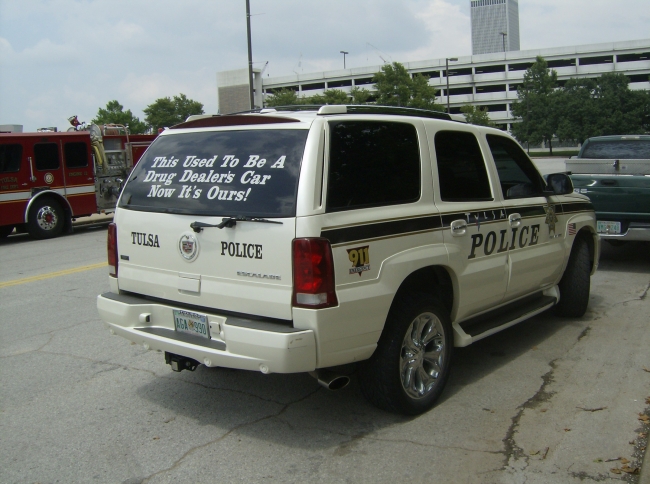 This is a picture I took while in Tulsa, OK of a Tulsa police car that says on the back window, This Used To Be A Drug Dealers Car Now Its Ours! This  for a car show. This is a real cop car driven by Tulsa police officers trying to prove a point. I thought is was funny and I hope others do too..