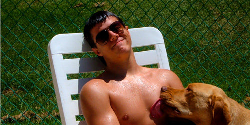 Picture of my dog, Buster Brown, licking the water from the pool off my nipple.