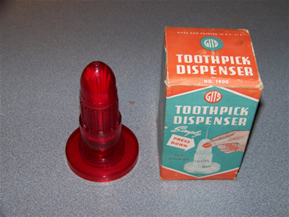 This is a vintage toothpick holder that looks strangely like a sex toy.  There are more pics on ebay where it is for sale.  Just search for phallic toothpick dispenser.
