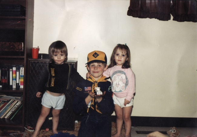 Boy in blue shorts sportin wood.  A LITTLE young???