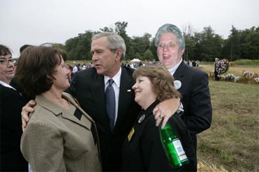 Check out George Bush with the bottle in his hand and getting ready to give that woman a kiss