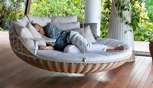 person sleeping on a bed suspended in the air