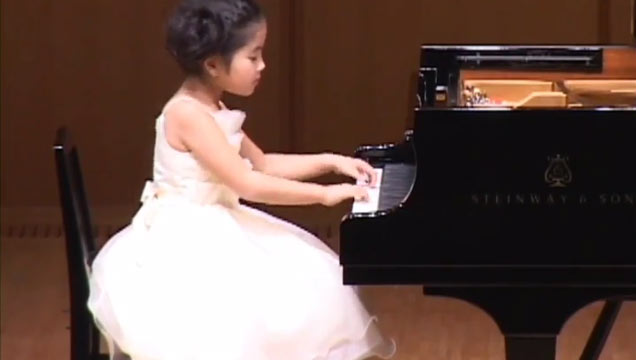 girl in white dress playing piano