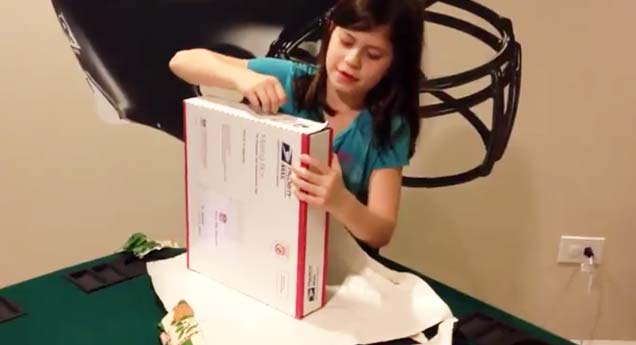 a little girl opening up a box on christmas day