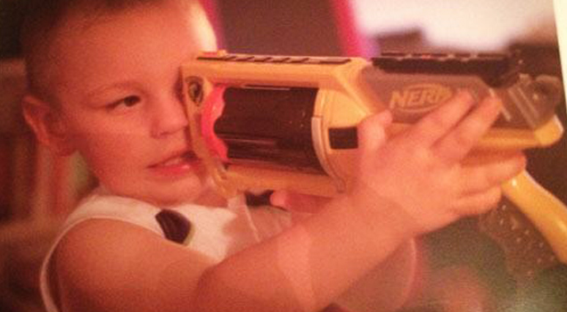 kid looking down nerf gun barrel