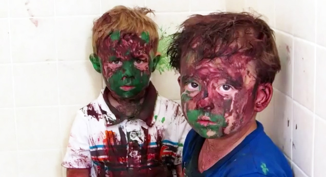 two brothers covered in red and green paint