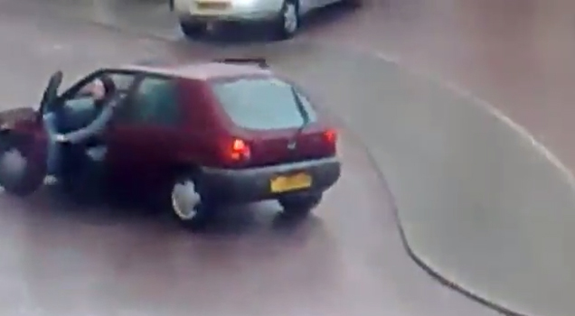 woman jumping from red car on icy road