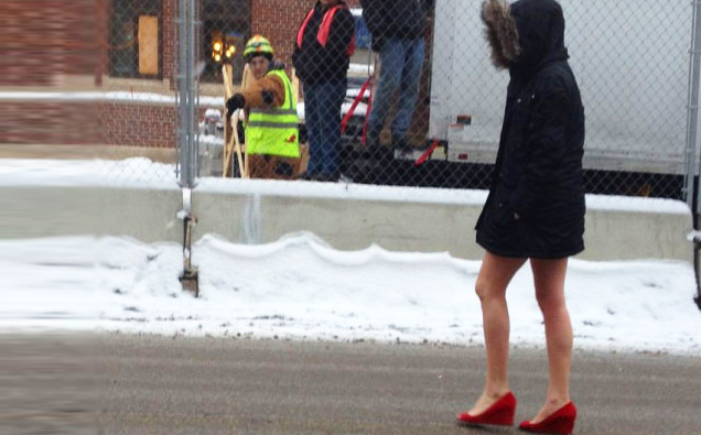 girl in the snow with no pants and red high heels