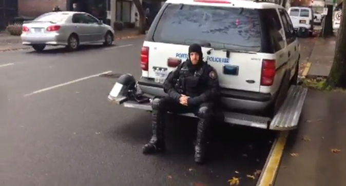 riot cop sitting down