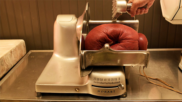 boxing glove in meat slicer