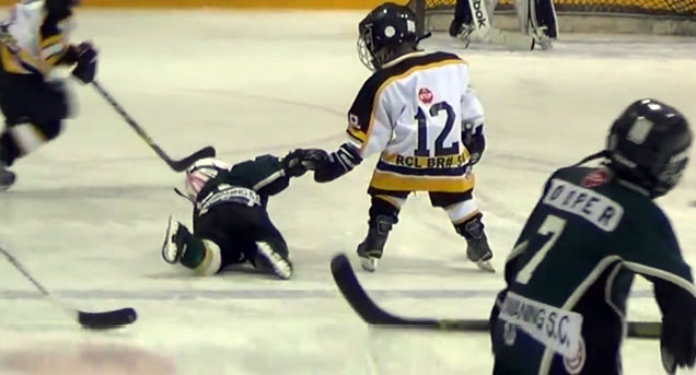 tiny hockey player helps another