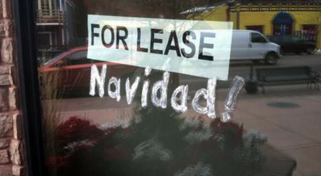 window sign that says for lease navidad