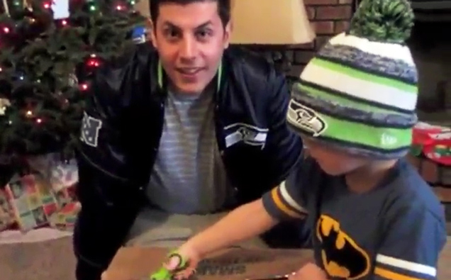 father and son seattle seahawks fans opening box