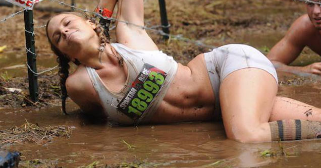 hot chick climbs under barb wire, through mud and looks fabulous.