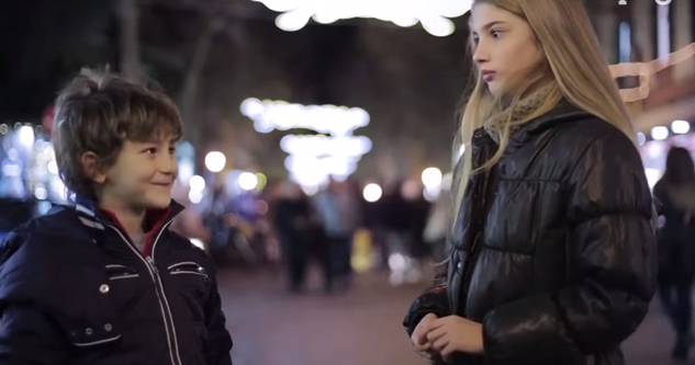 little boy smiles at a shocked girl.