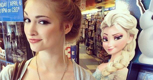 A young woman looks like, and mimics the facial expression of, Elsa from the movie Frozen.