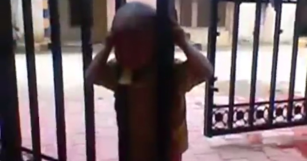 Kid's head is stuck in a gate.