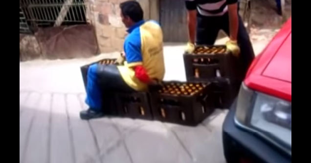 delivery guy rides beer sled down steep hill