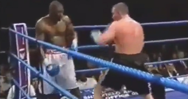 Boxers stand in a ring, ready to punch. One boxer has a dislocated shoulder.