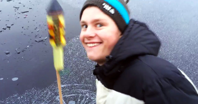 guy grinning with firework in hand