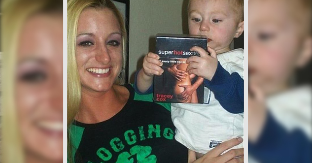 Hot woman is holding a baby who is holding a porn DVD.