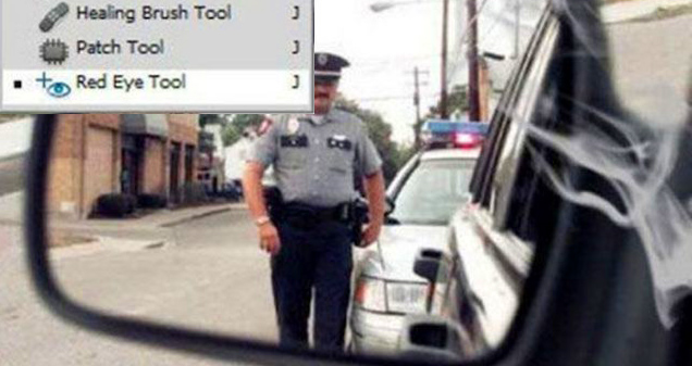 reflection of a cop walking toward a car and photoshop toolbar with the remove red eye tool selected