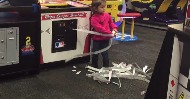 girl pulls tickets out of machine