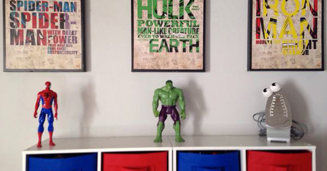 An spider-man action figure under a picture of spider-man. a hulk action figure under a picture of hulk. an iron with googly eyes under a picture of an iron.