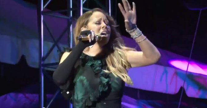 Mariah Carey in a live performance pretending to belt out tunes.