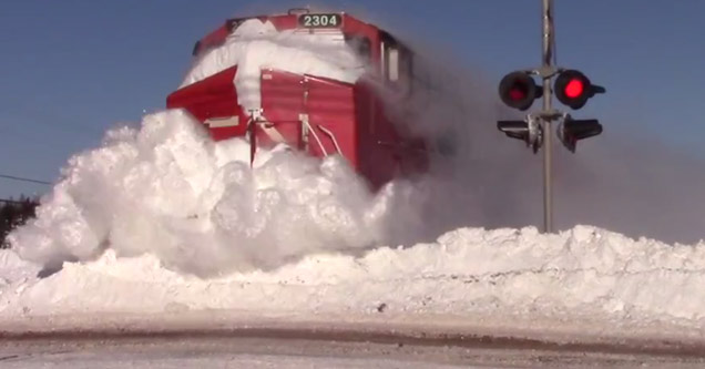 train plows through snow