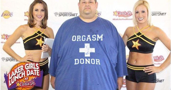 Fat man standing between two hot girls. Man's shirt says: Orgasm Donor