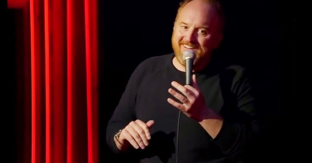 Louis CK smiling on stage